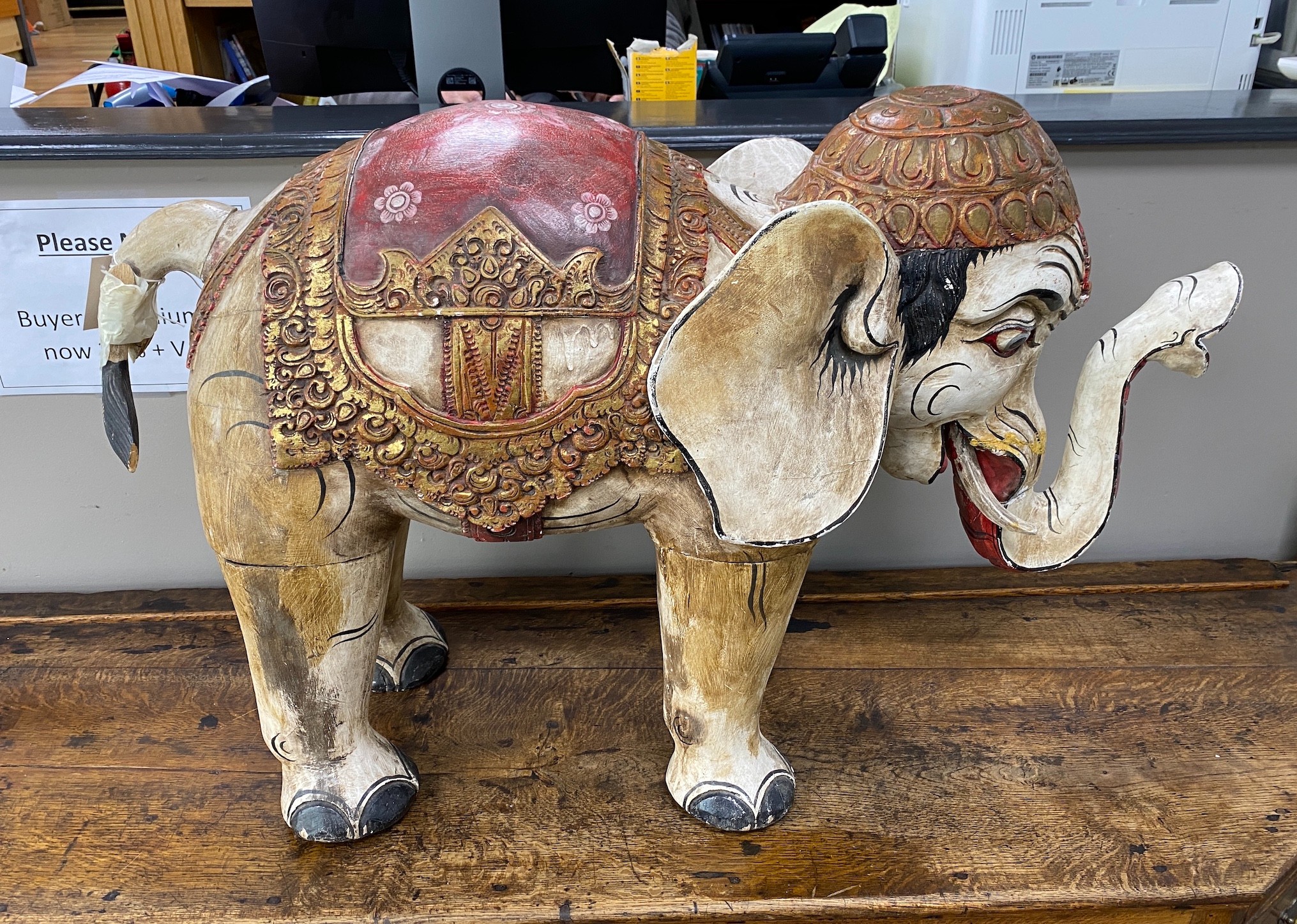 A large Indonesian painted wood model of an elephant, length 92cm, height 60cm